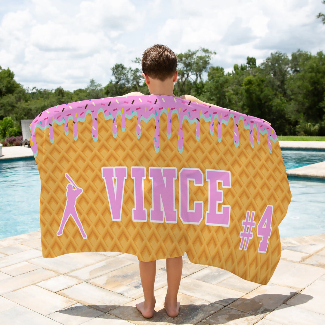 Ice Cream Drip Baseball Personalized Beach Towel - Pink/Blue Boy holding a towel by a pool