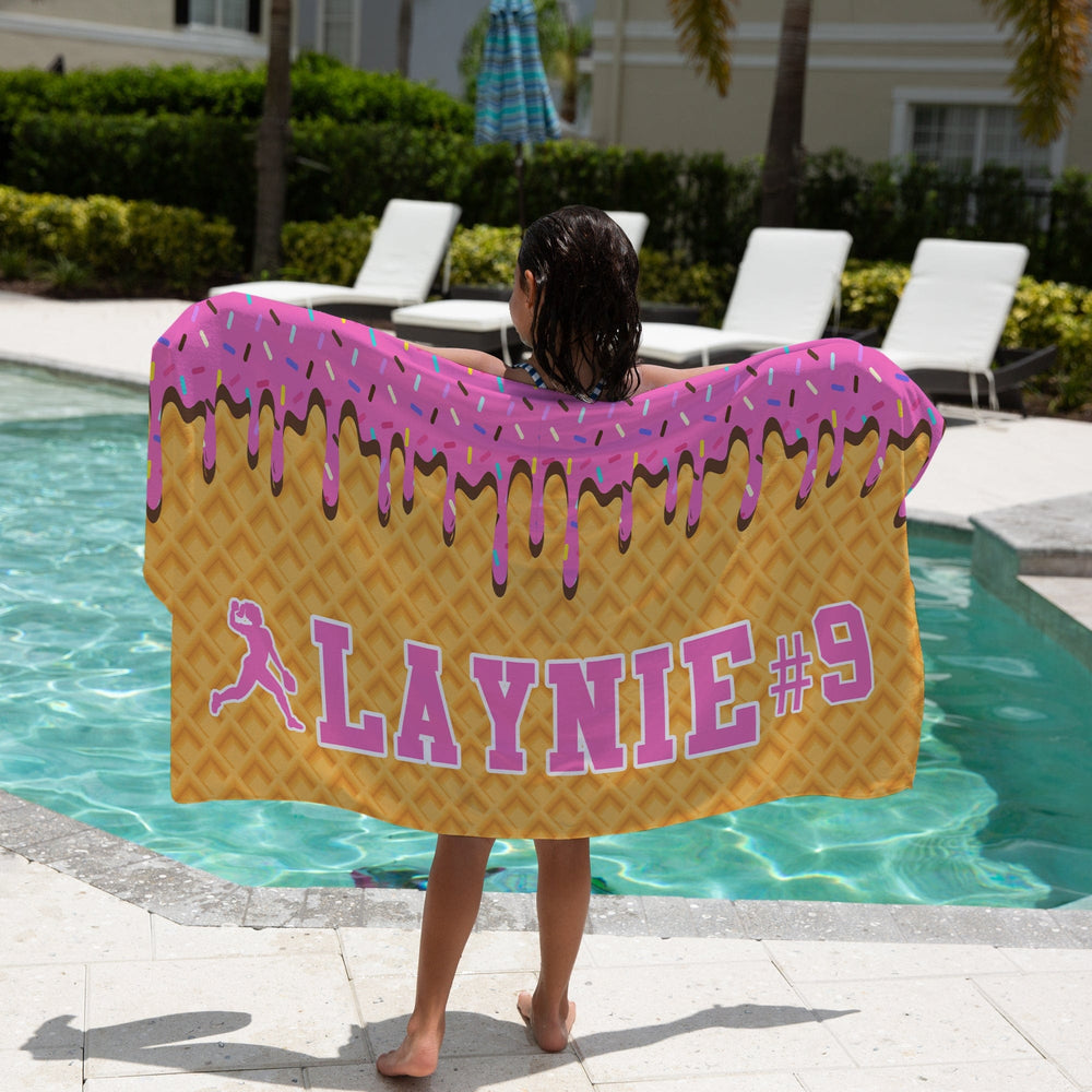 Ice Cream Drip Softball Personalized Beach Towel - Pink with a girl holding the towel next to a pool